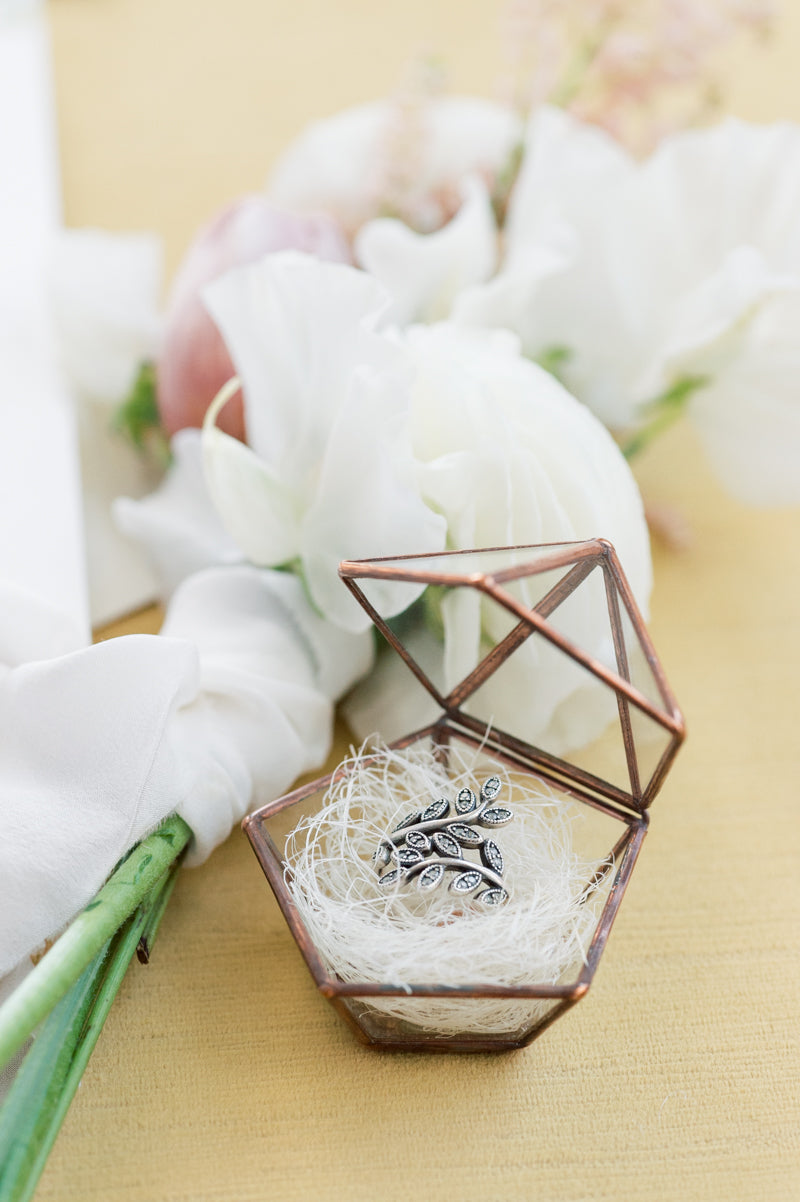 Close Up of Yellow Styling Mat, Bronze and Glass Ring Box with Leaf Ring